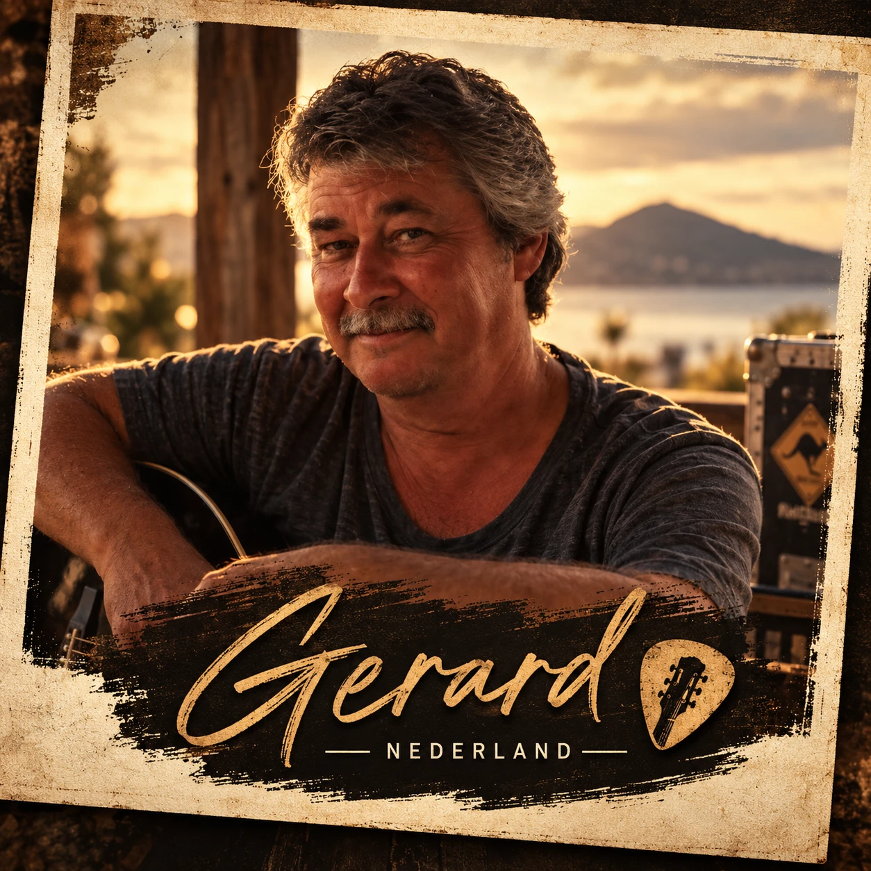 Gerard Brock with a guitar in warm evening light